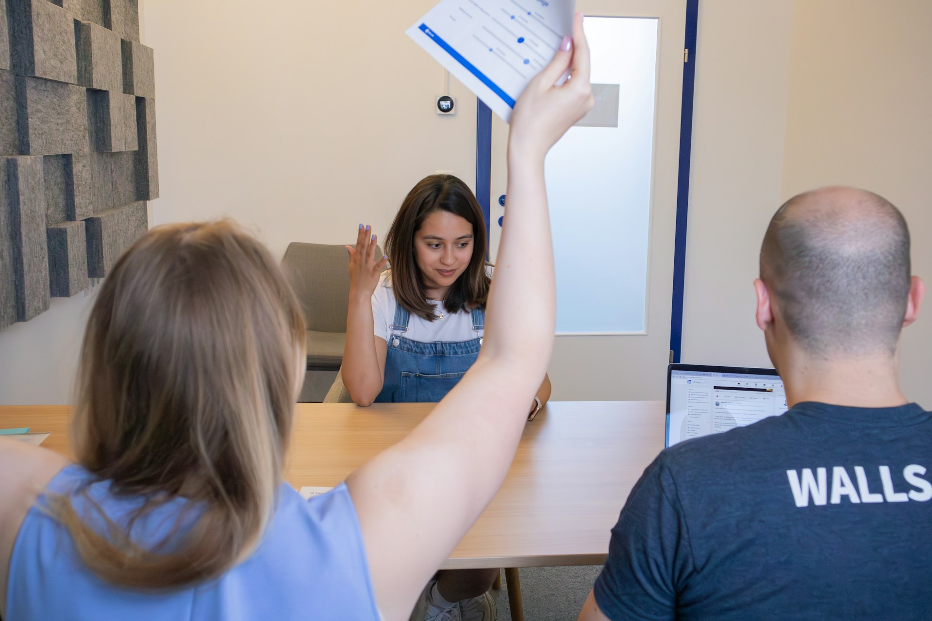 New volunteer being warmly welcomed by staff during onboarding with credential verification at a faith-based organization